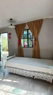 a bedroom with a bed and two windows at La aurora in Pantanillo