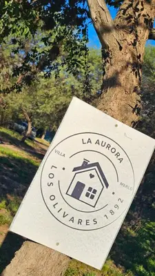 a sign on a tree with a house on it at La aurora in Pantanillo