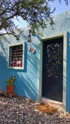 a blue house with a blue door and a window at La aurora in Pantanillo