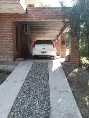 a white car is parked in a garage at Ojos de cielo Monoambientes para 2 y 3 personas in Bialet Massé