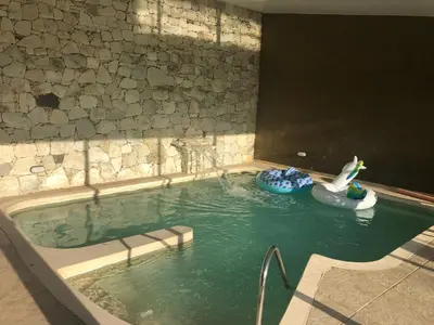 a swimming pool with a swan and a toy in it at Apart-Hotel Gibert's House in Villa Carlos Paz
