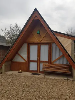 a wooden building with a bench in front of it at La Estacion in Santa Rosa de Calamuchita