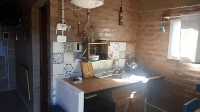 a small kitchen with a counter and a sink at La Estacion in Santa Rosa de Calamuchita