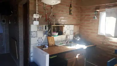 a small kitchen with a counter and a sink at La Estacion in Santa Rosa de Calamuchita