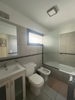 a bathroom with a toilet and a sink and a mirror at Ituzaingó 1054 - cochera, pileta y quincho- in Cordoba