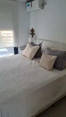 a large white bed with pillows on top of it at Ituzaingó 1054 - cochera, pileta y quincho- in Cordoba