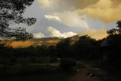 a rainbow in the sky over a mountain at TrinidadTraslasierra-CASATUNA in Las Rabonas