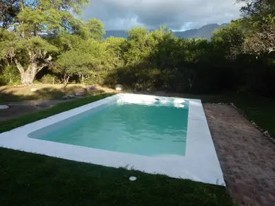 a swimming pool in the middle of a yard at TrinidadTraslasierra-CASATUNA in Las Rabonas