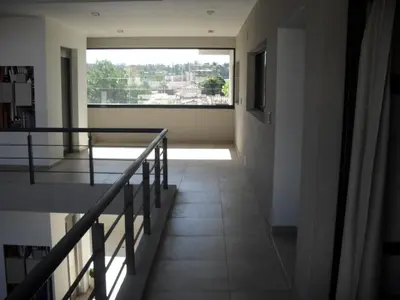 a hallway of a building with a large window at Village Tower in Villa Carlos Paz