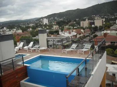 a swimming pool on the roof of a building at Village Tower in Villa Carlos Paz