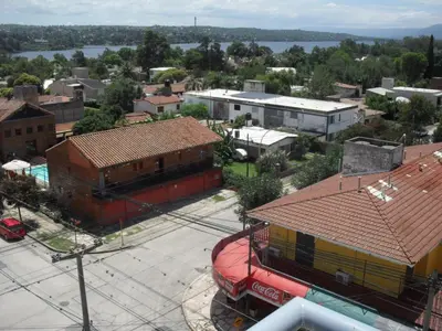 an aerial view of a town with buildings and a river at Village Tower in Villa Carlos Paz