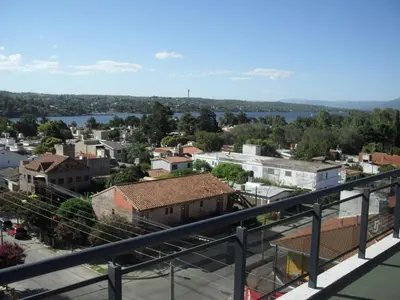 a view of a city from a balcony at Village Tower in Villa Carlos Paz