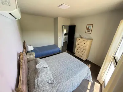 a small bedroom with a bed and a dresser at Sierra Alta Carlos Paz in Villa Carlos Paz