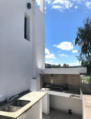 a white kitchen with a sink and a window at Sierra Alta Carlos Paz in Villa Carlos Paz