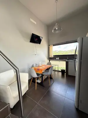 a kitchen and dining room with a table and chairs at Sierra Alta Carlos Paz in Villa Carlos Paz