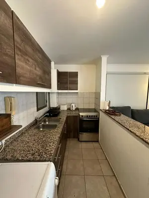 a kitchen with a sink and a counter top at Departamento 1 dorm amoblado Nueva Córdoba 6 E INVERHOME INMOBILIARIA in Cordoba