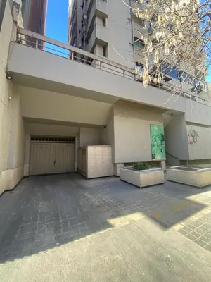 a building with two garage doors and a balcony at Departamento 1 dorm amoblado Nueva Córdoba 6 E INVERHOME INMOBILIARIA in Cordoba