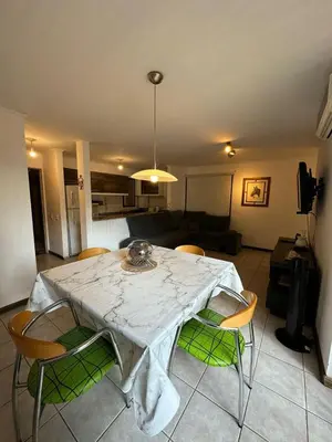 a table and chairs in a living room at Departamento 1 dorm amoblado Nueva Córdoba 6 E INVERHOME INMOBILIARIA in Cordoba
