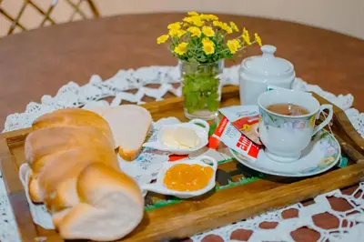 a tray with a sandwich and a cup of tea at Le Bon Repos in Alta Gracia