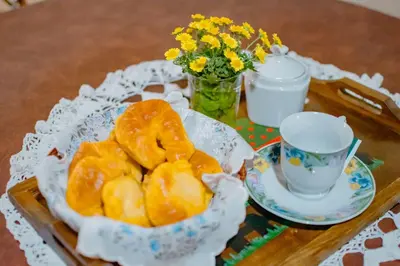 a table with a plate of doughnuts and a cup of coffee at Le Bon Repos in Alta Gracia