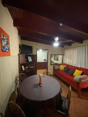 a living room with a table and a couch at Le Bon Repos in Alta Gracia