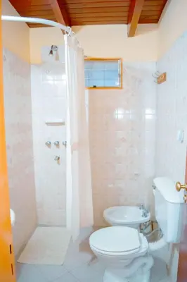 a bathroom with a toilet and a shower and a sink at Le Bon Repos in Alta Gracia