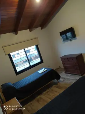 a bedroom with a bed and a window and a dresser at Casa 3 dormitorios. - Barrio Valle Cercano in Cordoba