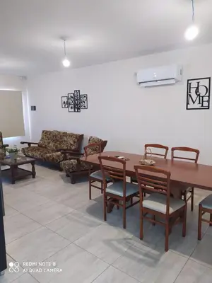 a living room with a table and chairs and a couch at Casa 3 dormitorios. - Barrio Valle Cercano in Cordoba