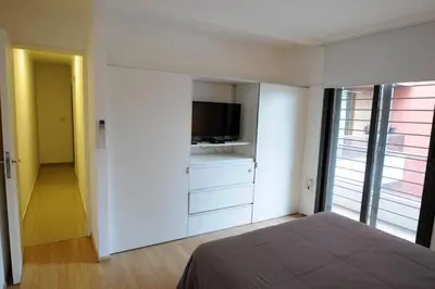 a bedroom with a bed and a flat screen tv at Tu lugar en Córdoba. in Cordoba