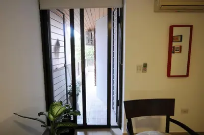 a room with a door open to a patio with a plant at Tu lugar en Córdoba. in Cordoba
