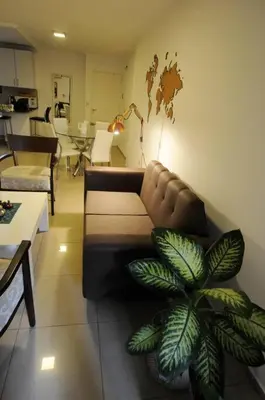 a living room with a couch and a plant at Tu lugar en Córdoba. in Cordoba