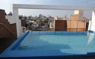 a swimming pool on the roof of a building at Tu lugar en Córdoba. in Cordoba