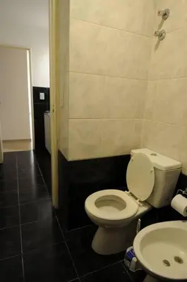 a bathroom with a toilet and a sink at Tu lugar en Córdoba. in Cordoba