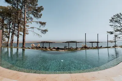 a pool of water with a beach in the background at Get Hotel Molvento, AKEN SOUL Collection in Villa General Belgrano