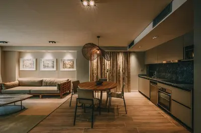 a kitchen and living room with a table and a couch at Get Hotel Molvento, AKEN SOUL Collection in Villa General Belgrano