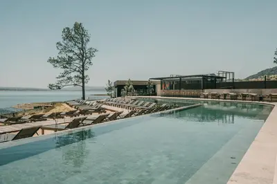 a large swimming pool with lounge chairs and water at Get Hotel Molvento, AKEN SOUL Collection in Villa General Belgrano