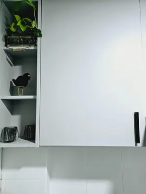 a white cupboard with a black bird sitting on it at MilcaCeleste Nueva Cordoba II in Cordoba