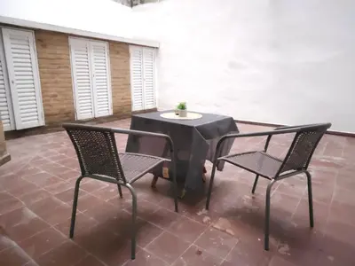 a black table and two chairs on a patio at MilcaCeleste Nueva Cordoba II in Cordoba