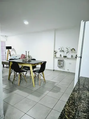 a kitchen with a table and chairs and a refrigerator at MilcaCeleste Nueva Cordoba II in Cordoba