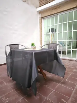 a table with a black table cloth on a patio at MilcaCeleste Nueva Cordoba II in Cordoba