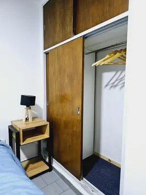 a bedroom with a door and a bed and a table at MilcaCeleste Nueva Cordoba II in Cordoba