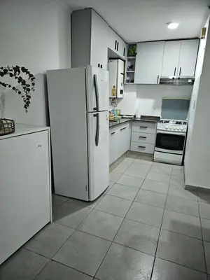 a kitchen with white cabinets and a refrigerator at MilcaCeleste Nueva Cordoba II in Cordoba