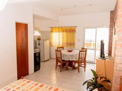 a kitchen and dining room with a table and chairs at Depto 2 in Villa Carlos Paz