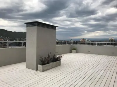 a balcony with plants on top of a building at Departamento Opera Torre 2 in Villa Carlos Paz
