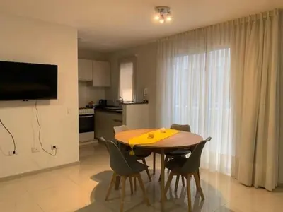 a dining room table and chairs in a kitchen at Departamento Opera Torre 2 in Villa Carlos Paz