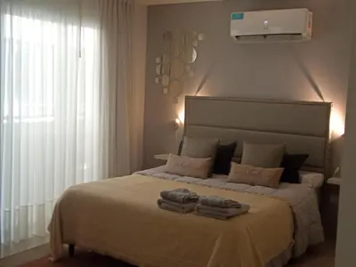 a bedroom with a large bed with towels on it at Departamento Opera Torre 2 in Villa Carlos Paz