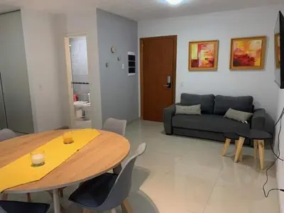 a living room with a table and a couch at Departamento Opera Torre 2 in Villa Carlos Paz