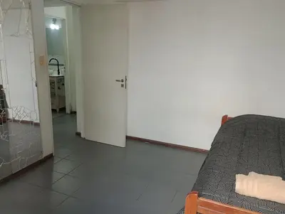 a living room with a bed and a hallway at La casa de Emma in Cordoba