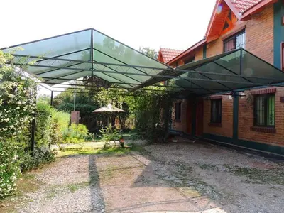 a glass canopy over a patio of a house at Alma Mora in Merlo