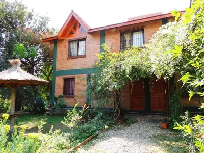 a brick house with a gazebo in a yard at Alma Mora in Merlo